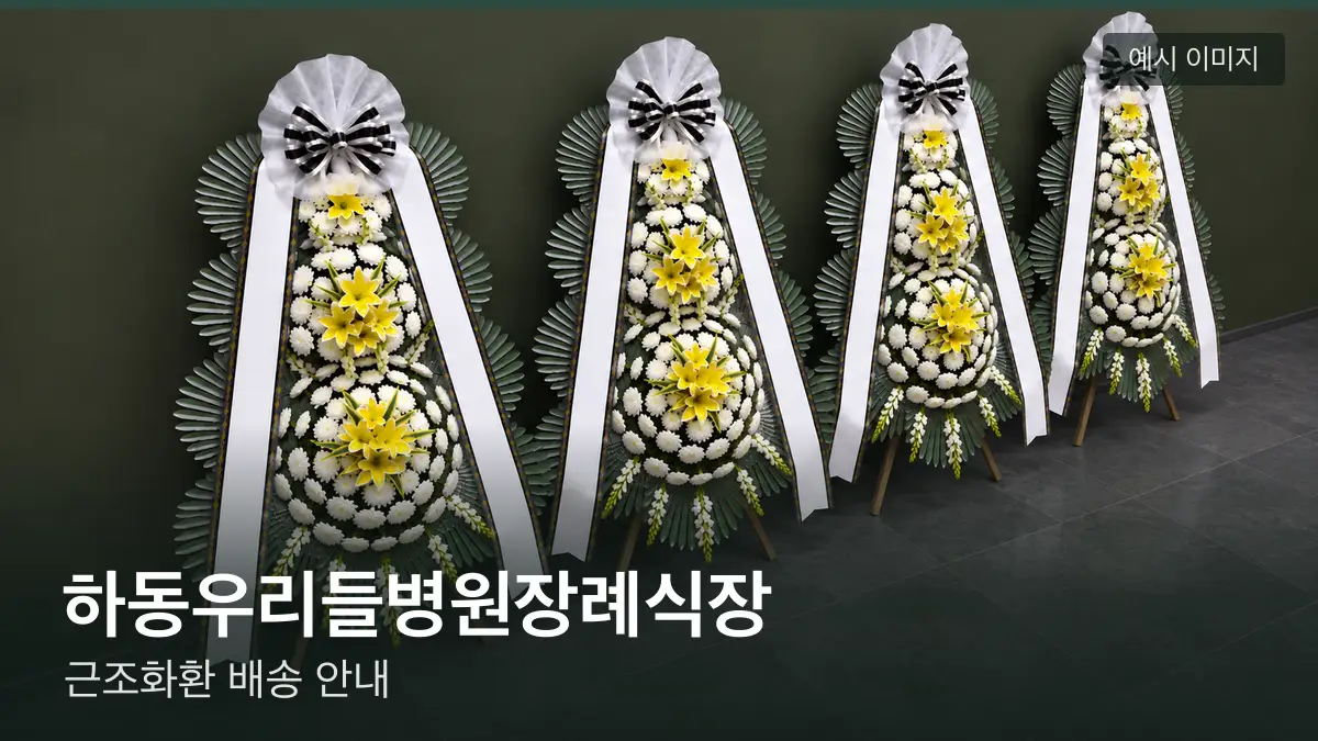 하동우리들병원장례식장 근조화환 예시 이미지 — 흰 국화 3단 근조화환이 벽을 따라 나란히 놓인 모습