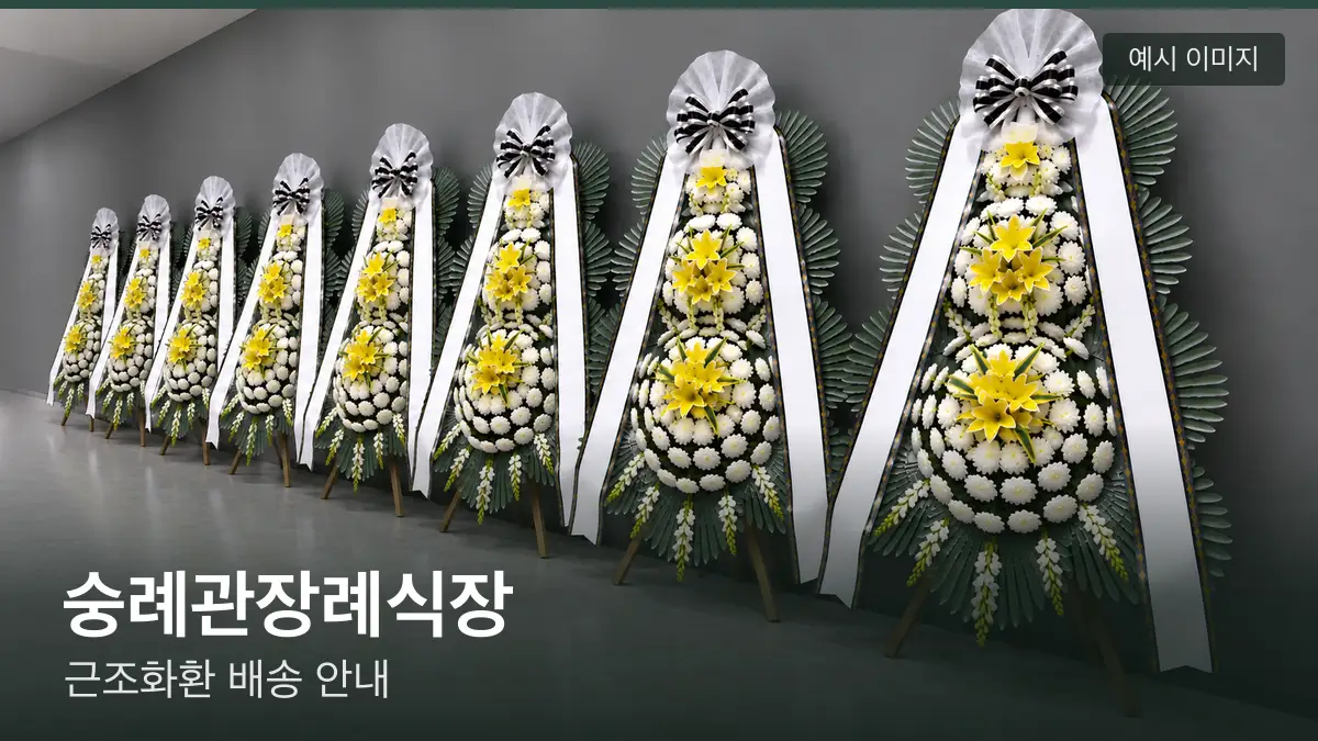 숭례관장례식장 근조화환 예시 이미지 — 흰 국화 3단 근조화환이 벽을 따라 나란히 놓인 모습