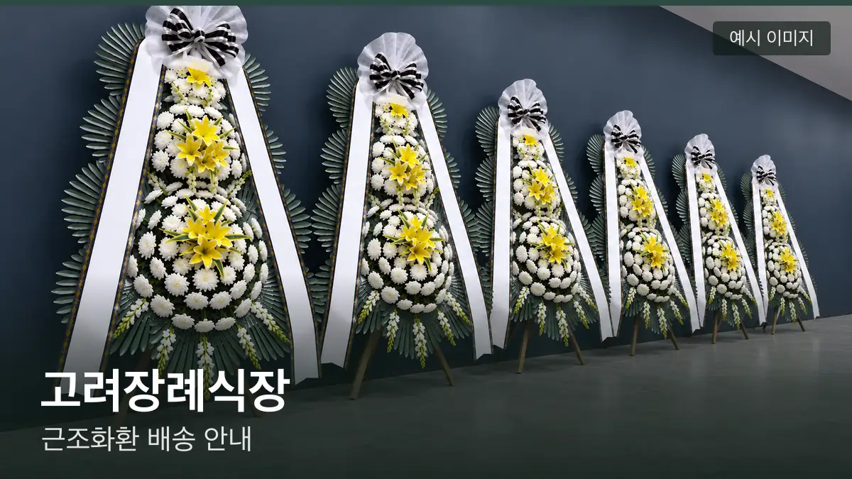 고려장례식장 근조화환 예시 이미지 — 흰 국화 3단 근조화환이 벽을 따라 나란히 놓인 모습